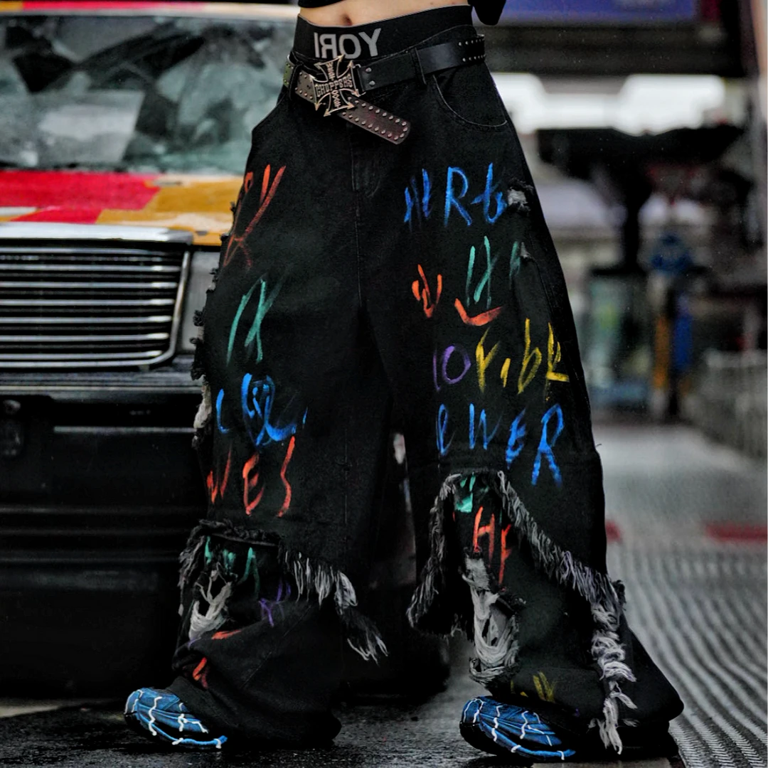 Sanhoostudio convertible denim pants featuring detachable long-to-short functionality, distressed wash treatment, and a wide leg scythe-cut silhouette. Designed for versatile streetwear styling with comfort and standout visual appeal.