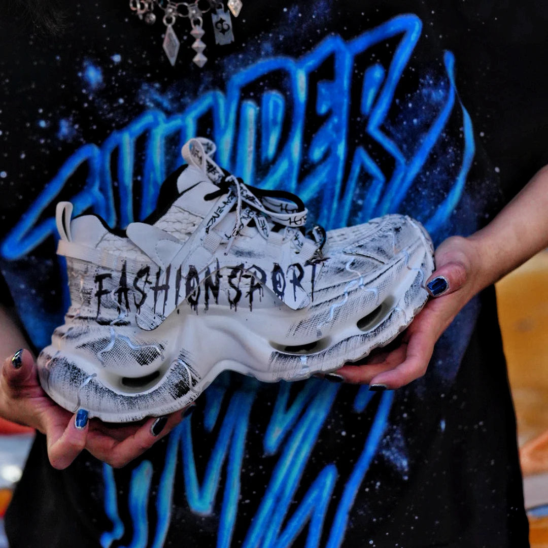 Sanhoostudio dad sneakers featuring grey and white graffiti-inspired detailing, cushioned sole construction, and a modern streetwear silhouette. Designed for everyday comfort, versatile styling, and standout urban fashion appeal with all-day wearability.