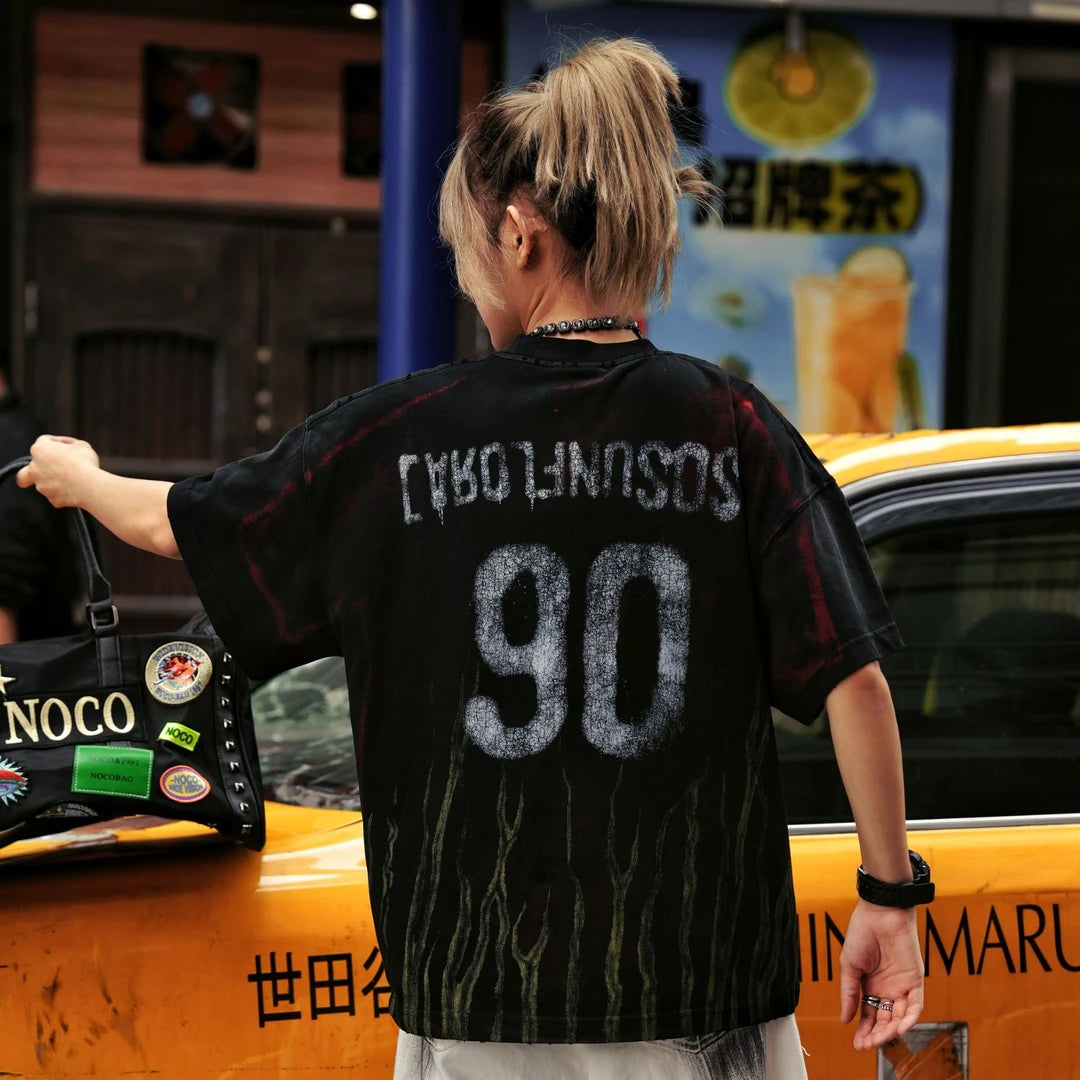 Sanhoostudio jersey-inspired short sleeve T-shirt featuring flame graphics, studded details, and a loose oversized fit. Built for retro streetwear outfits with breathable comfort and standout visual appeal.
