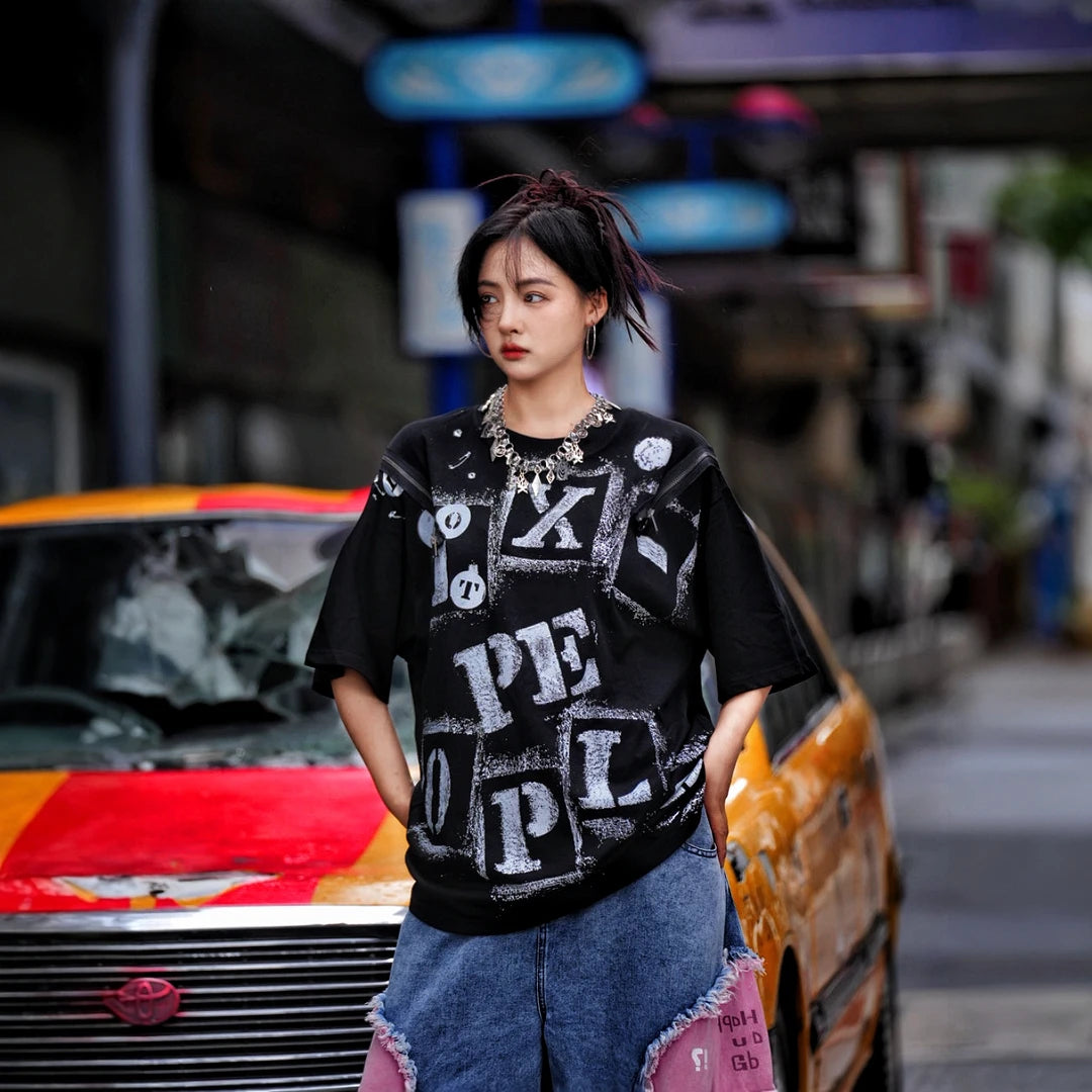 Sanhoostudio short sleeve T-shirt featuring fracture-inspired spray-print artwork, breathable fabric construction, and a relaxed oversized fit. Built for summer streetwear outfits with lightweight comfort and standout graphic styling.