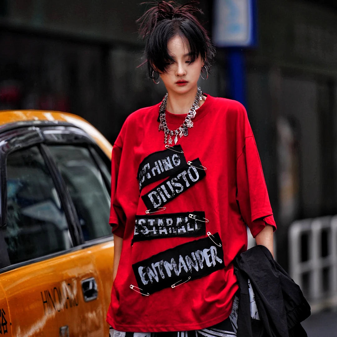Sanhoostudio short sleeve T-shirt featuring red graphic artwork and breathable lightweight construction with an oversized fit. Designed for summer streetwear styling with standout visual impact and comfortable daily wear.