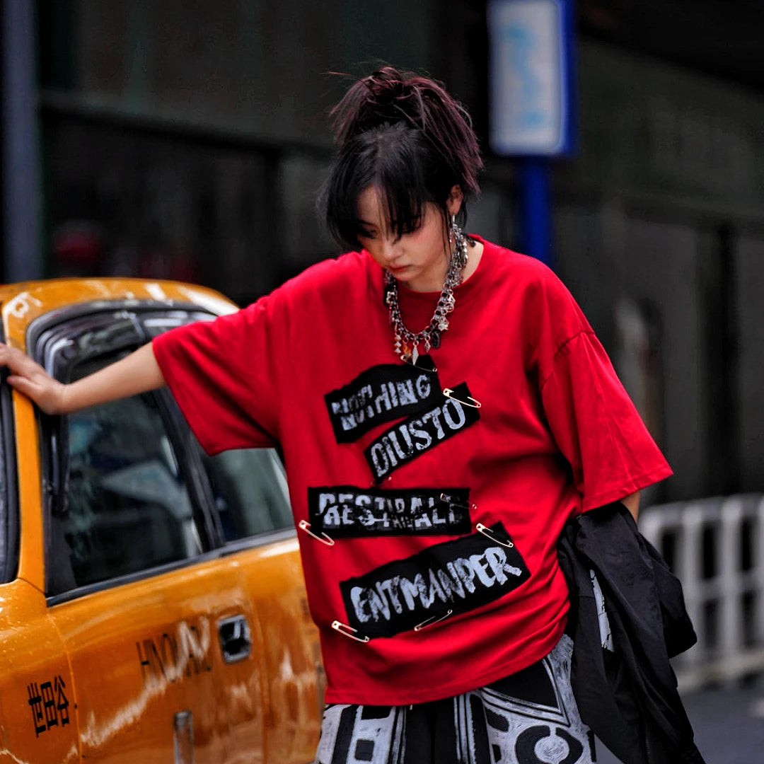 Sanhoostudio short sleeve T-shirt featuring red graphic artwork and breathable lightweight construction with an oversized fit. Designed for summer streetwear styling with standout visual impact and comfortable daily wear.