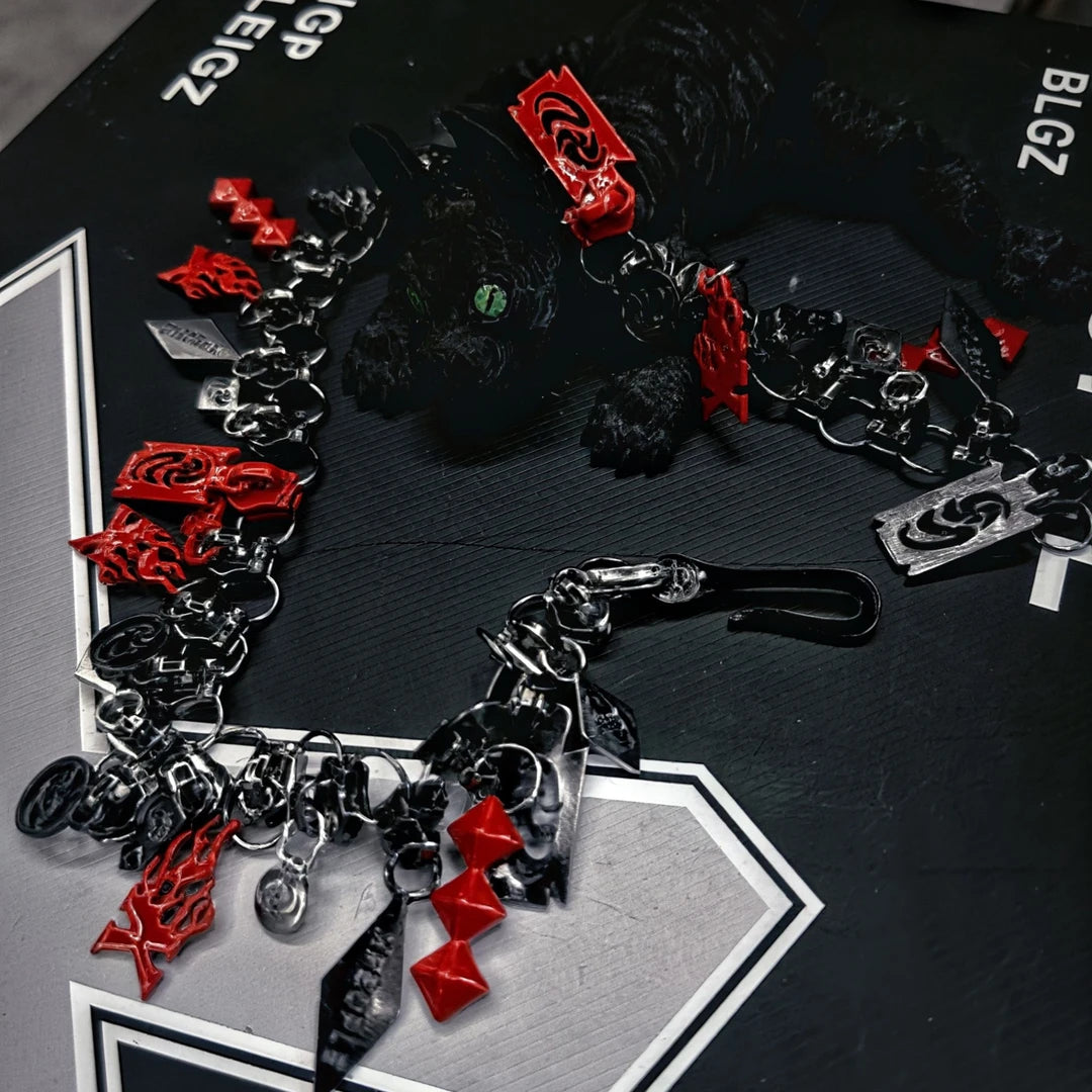 Sanhoostudio alloy necklace featuring multiple zipper-pull pendants and a heavyweight punk-inspired design. Crafted for streetwear styling with bold layering, durable construction, and a distinctive urban aesthetic for everyday wear.