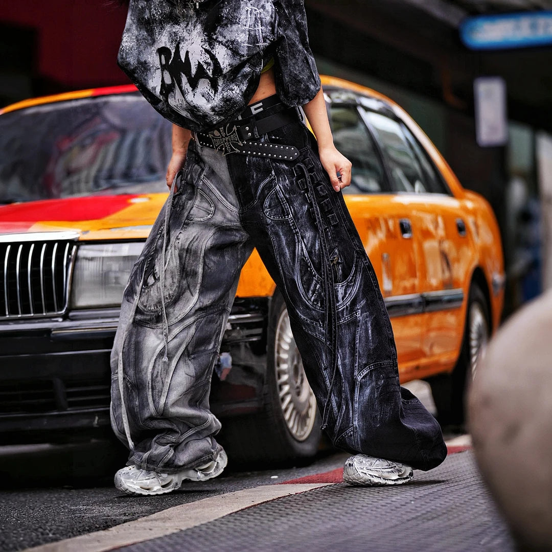 Sanhoostudio denim pants featuring distressed wash treatment, contrast panel construction, and a wide leg scythe-cut silhouette. Designed for futuristic streetwear styling with relaxed comfort and distinctive everyday appeal.