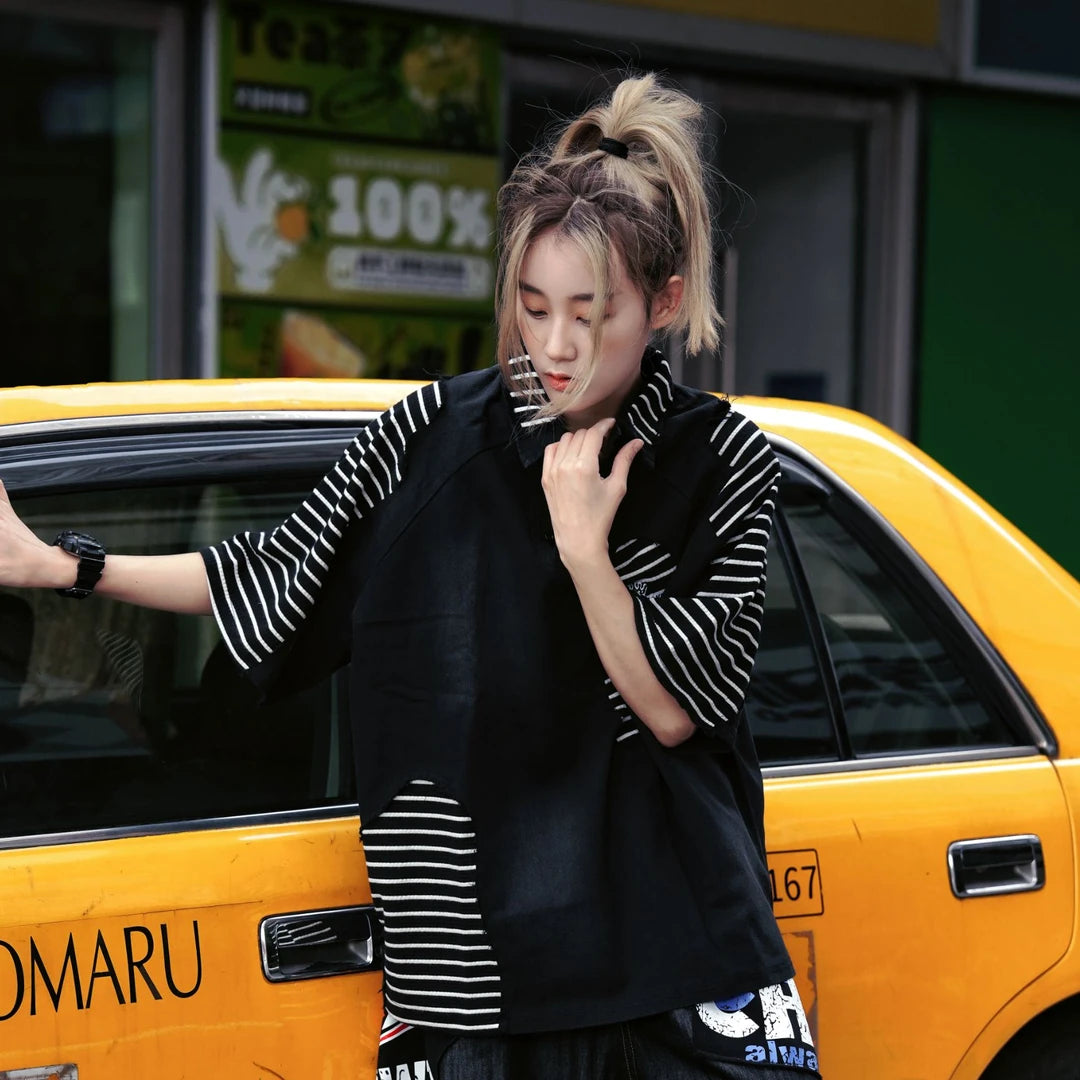 Sanhoostudio short sleeve T-shirt featuring colorblock patchwork styling, a relaxed oversized fit, and breathable fabric construction. Designed for everyday comfort with vintage college-inspired streetwear aesthetics.