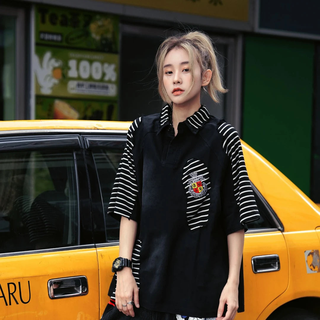 Sanhoostudio short sleeve T-shirt featuring colorblock patchwork styling, a relaxed oversized fit, and breathable fabric construction. Designed for everyday comfort with vintage college-inspired streetwear aesthetics.