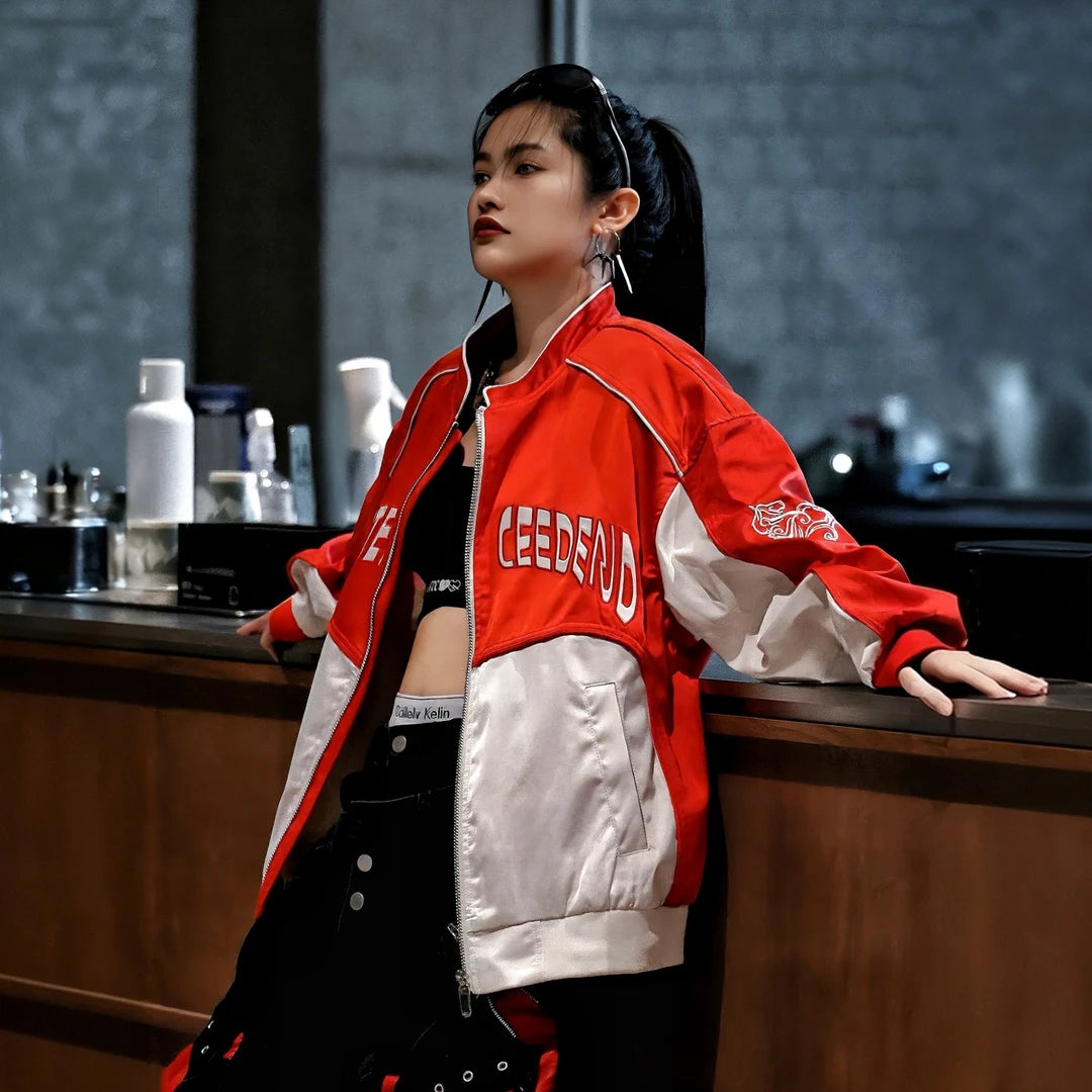 Sanhoostudio racing jacket featuring bold red and white colorblock panels, embroidered detailing, and a structured stand collar. Inspired by vintage motorsport style, this statement jacket combines relaxed streetwear comfort with a distinctive retro racing aesthetic.