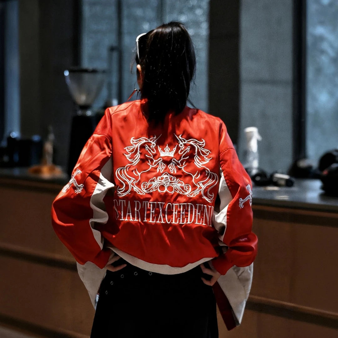 Sanhoostudio racing jacket featuring bold red and white colorblock panels, embroidered detailing, and a structured stand collar. Inspired by vintage motorsport style, this statement jacket combines relaxed streetwear comfort with a distinctive retro racing aesthetic.
