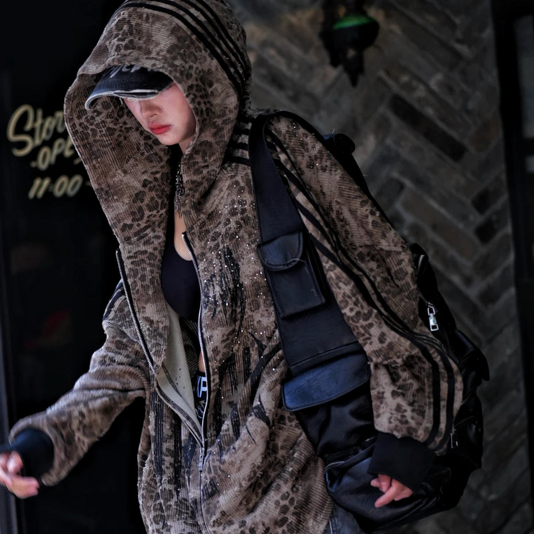 Sanhoostudio long sleeve cardigan featuring patchwork construction, graphic print details, and rhinestone embellishments with a relaxed oversized silhouette. Designed for early fall streetwear styling with bold visual texture, comfortable layering, and standout urban appeal.
