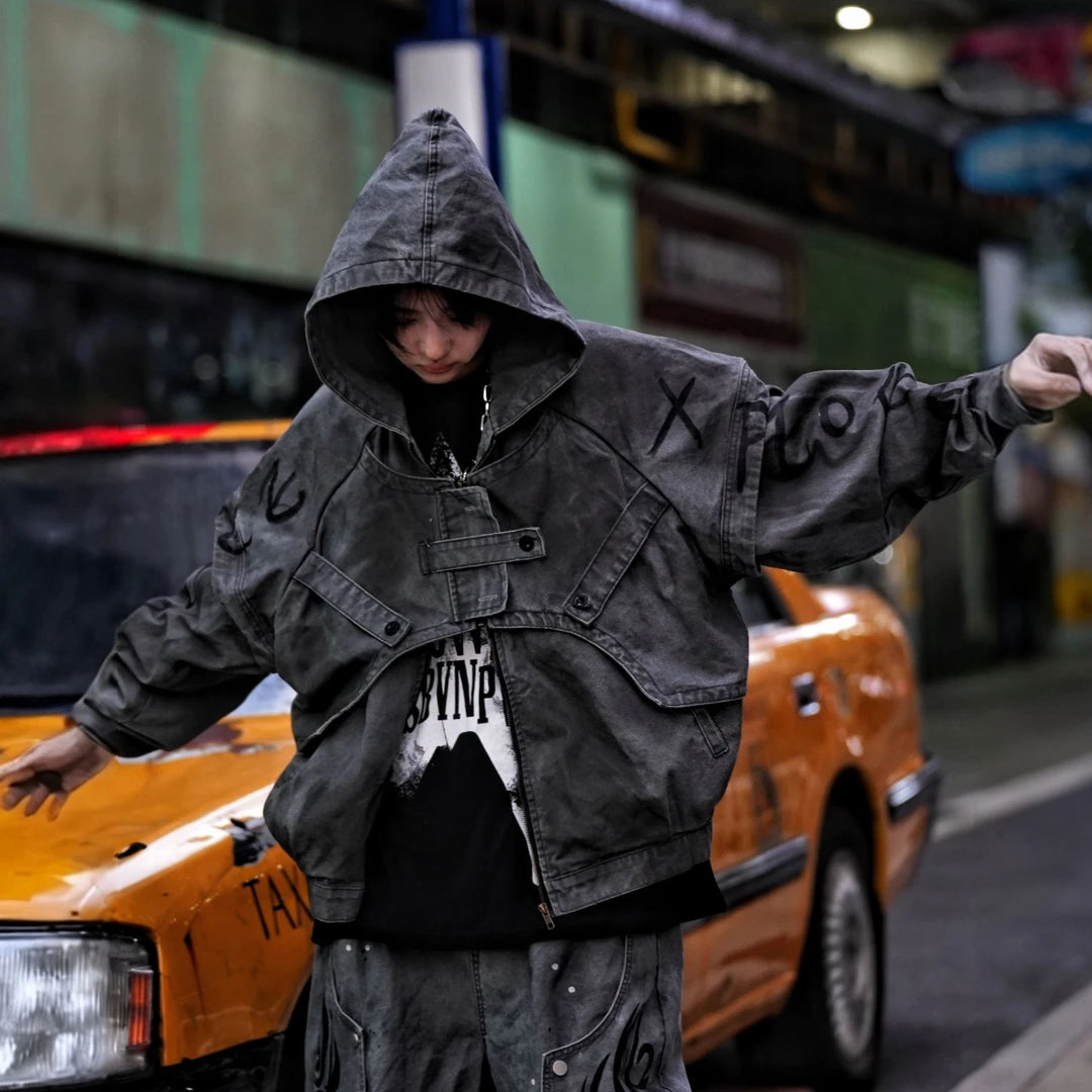 Sanhoostudio denim jacket featuring grey and black tones, hand-painted graffiti artwork, distressed staining, mud-dye treatment, and a relaxed oversized silhouette. Designed for statement streetwear layering with rich visual texture, vintage character, and bold urban appeal.