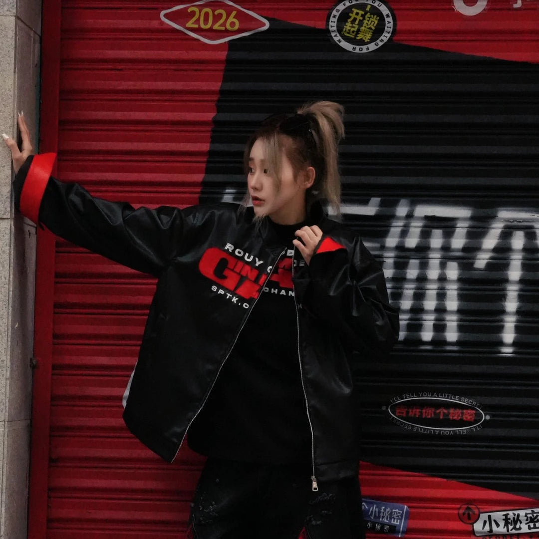 Sanhoostudio PU leather jacket featuring embroidered letter detailing, a structured shoulder silhouette, and vintage motorcycle-inspired styling. Designed for bold streetwear layering with a sleek leather look, versatile fit, and distinctive urban character.