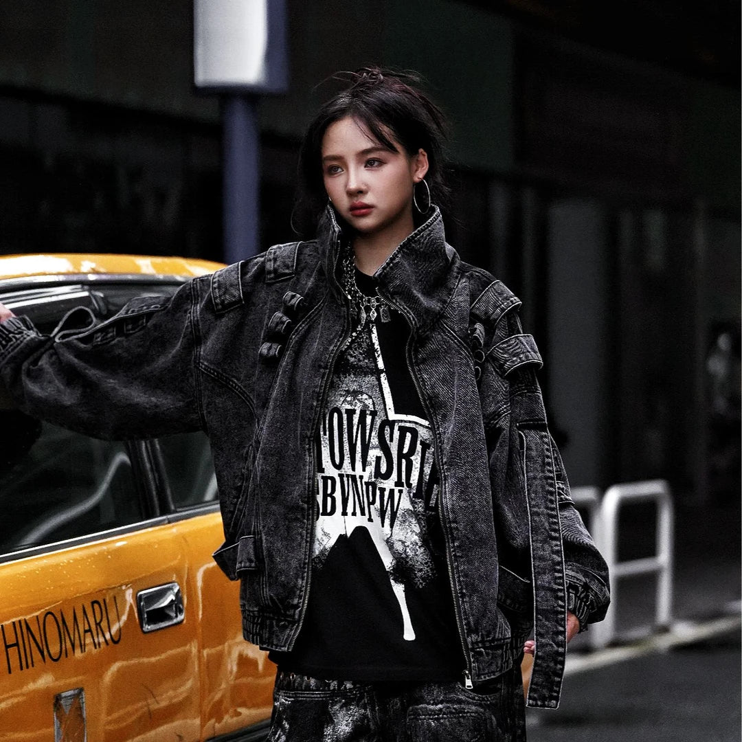 Sanhoostudio denim jacket featuring rock grey tones, hand-painted graffiti details, distressed staining, mud-dye treatment, and a relaxed oversized silhouette. Designed for statement streetwear layering with rugged visual texture, vintage-inspired character, and bold everyday urban styling.