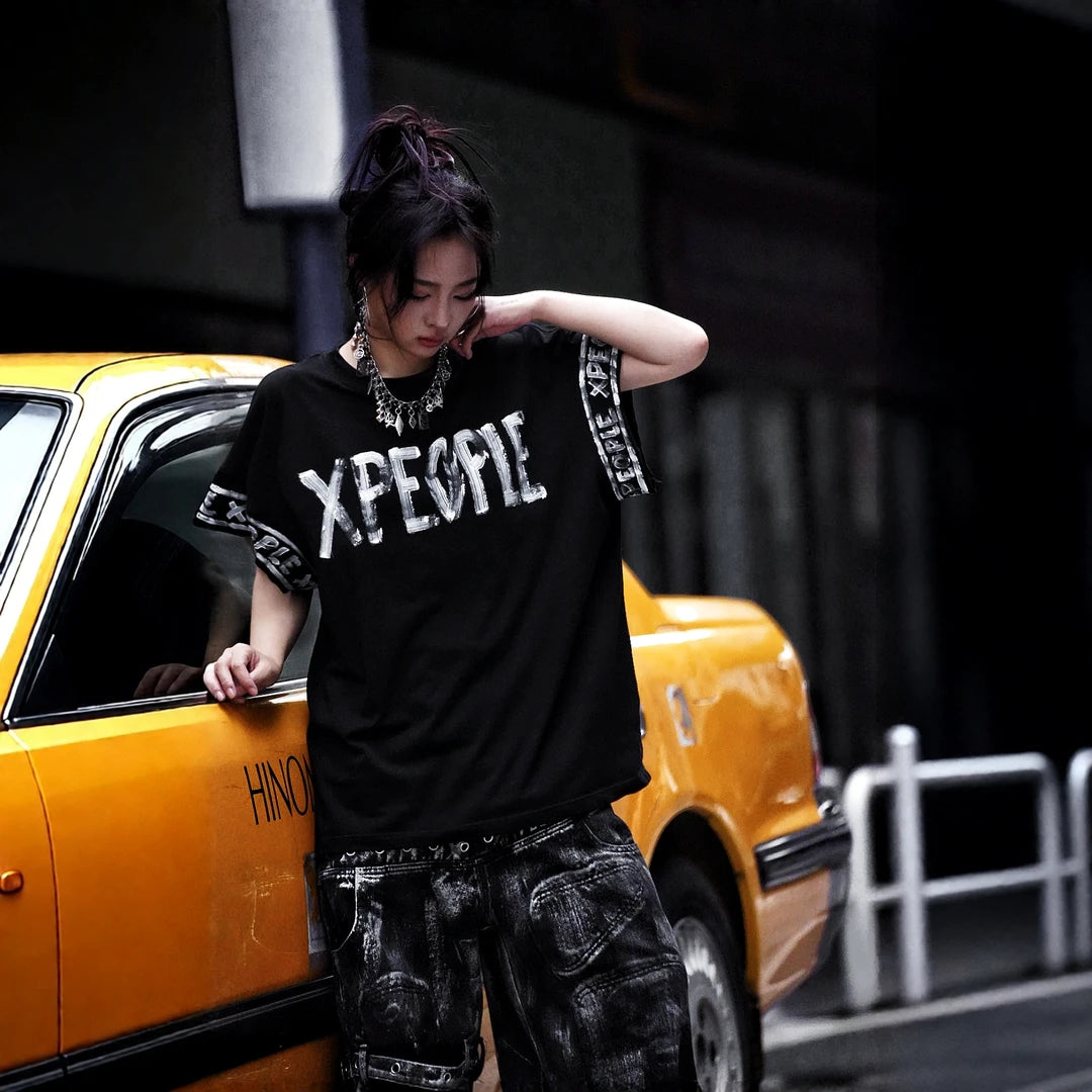 Sanhoostudio short sleeve T-shirt featuring hand-painted graphic artwork, contrast patchwork detailing, and a relaxed oversized silhouette. Designed for expressive streetwear styling with breathable everyday comfort, bold visual texture, and versatile urban appeal.