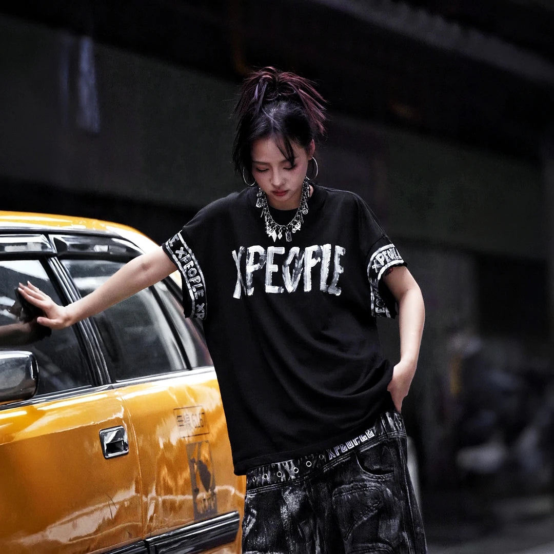 Sanhoostudio short sleeve T-shirt featuring hand-painted graphic artwork, contrast patchwork detailing, and a relaxed oversized silhouette. Designed for expressive streetwear styling with breathable everyday comfort, bold visual texture, and versatile urban appeal.