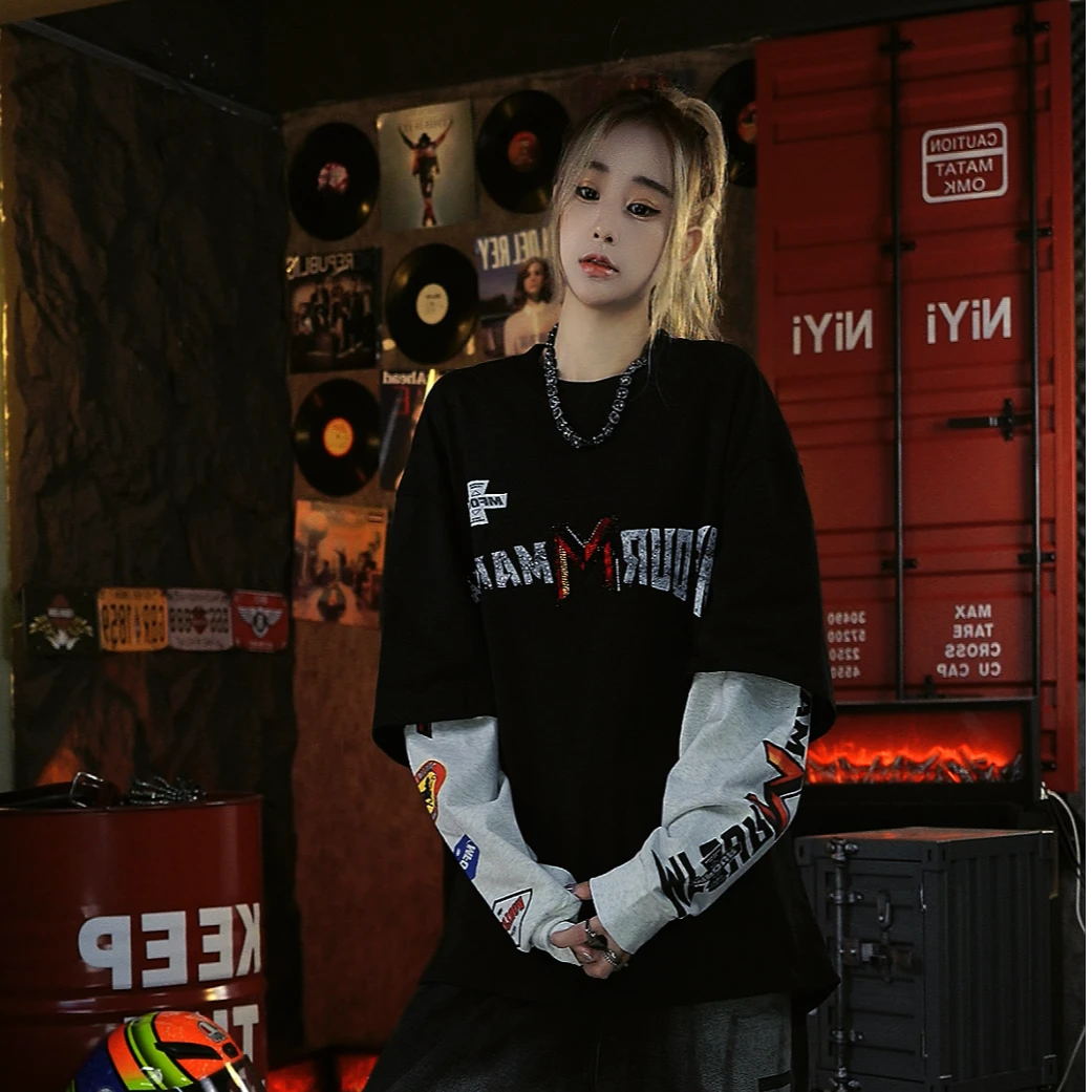 Sanhoostudio long sleeve T-shirt featuring rhinestone embellishments, contrast colorblock detailing, and a layered two-piece effect with a relaxed oversized fit. Designed for fall streetwear styling with standout texture, comfortable wear, and versatile unisex appeal.