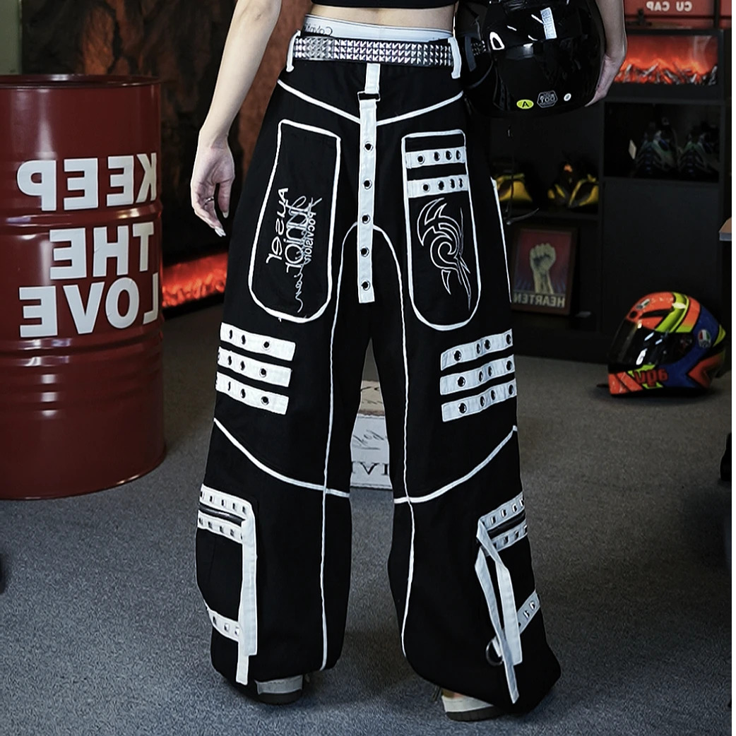 Sanhoostudio denim pants featuring distinctive tie-dye treatment, metal detailing, hanging strap accents, and a relaxed straight-leg silhouette. Designed with punk-inspired streetwear character for statement styling, comfortable movement, and bold contemporary urban outfits.