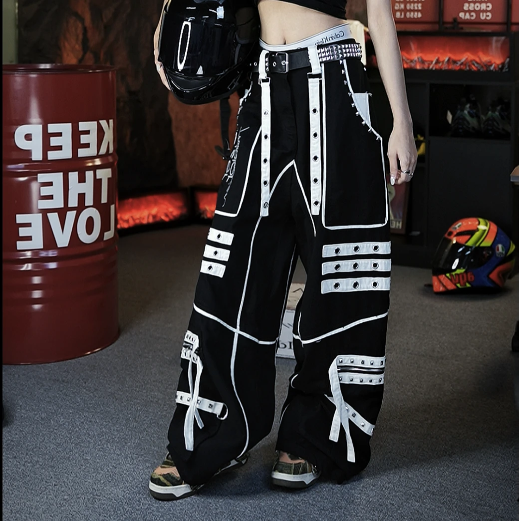 Sanhoostudio denim pants featuring distinctive tie-dye treatment, metal detailing, hanging strap accents, and a relaxed straight-leg silhouette. Designed with punk-inspired streetwear character for statement styling, comfortable movement, and bold contemporary urban outfits.