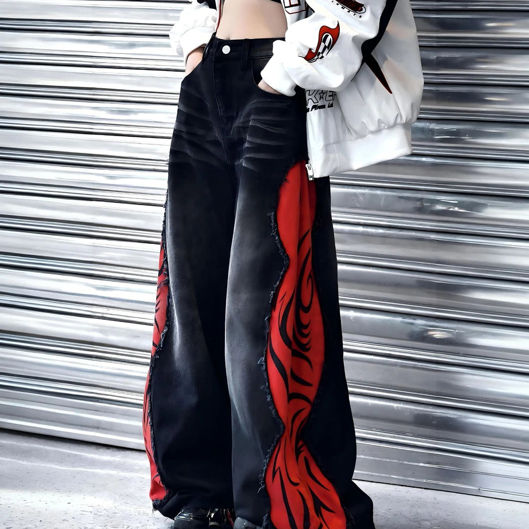 Sanhoostudio denim pants featuring flame-inspired patchwork, raw frayed detailing, and a relaxed wide leg silhouette with an extended floor-length cut. Designed for statement streetwear styling with bold contrast, vintage character, and effortless oversized proportions.