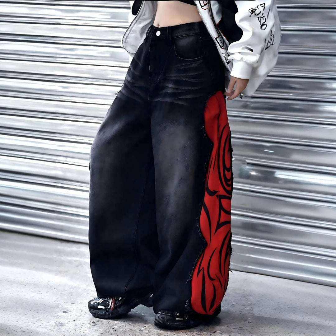 Sanhoostudio denim pants featuring flame-inspired patchwork, raw frayed detailing, and a relaxed wide leg silhouette with an extended floor-length cut. Designed for statement streetwear styling with bold contrast, vintage character, and effortless oversized proportions.