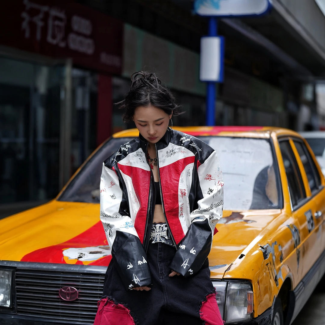 Sanhoostudio PU racing jacket featuring F2-inspired motorsport styling, contrast patchwork construction, and a relaxed oversized silhouette. Designed for early fall streetwear layering with bold racing character, comfortable movement, and distinctive urban appeal.