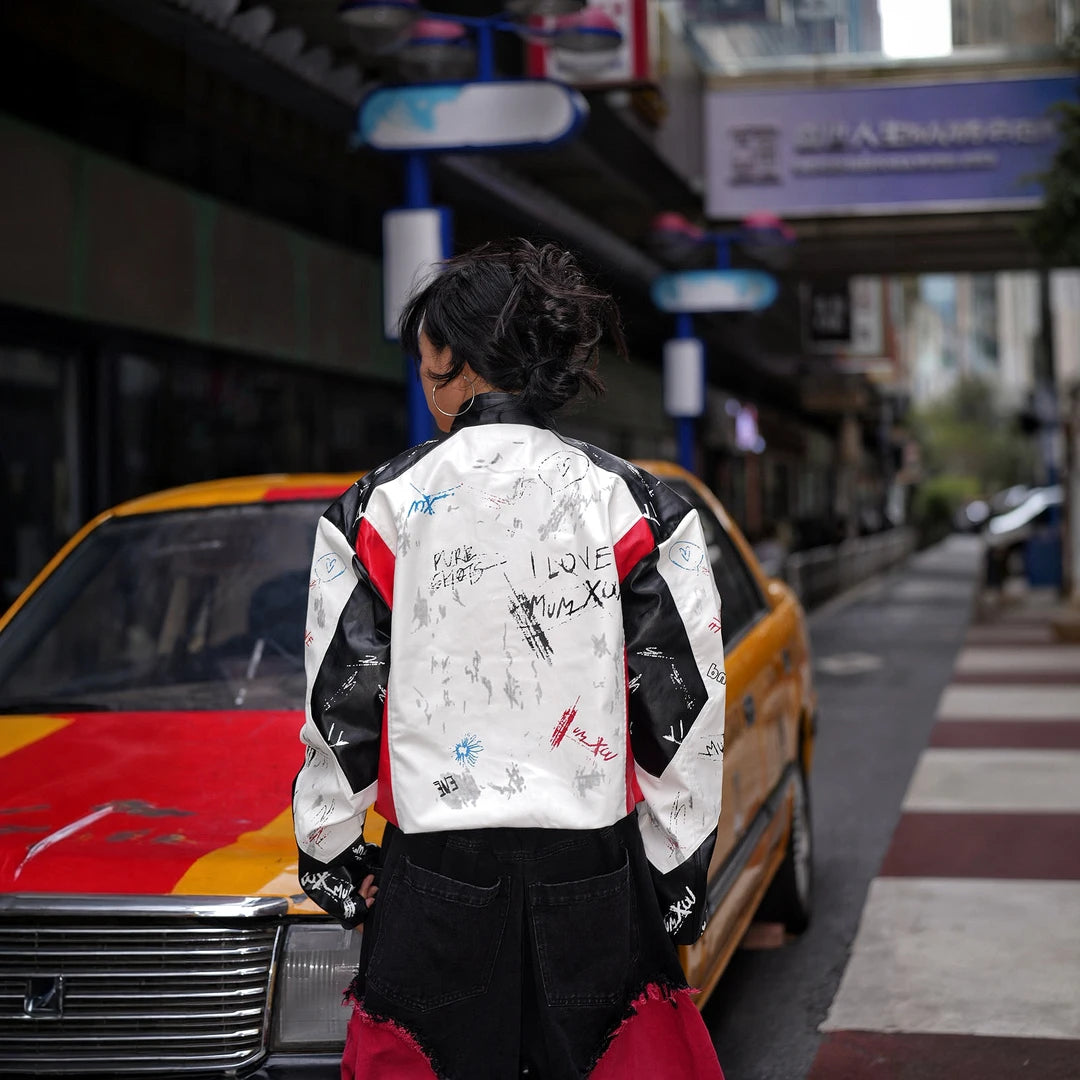 Sanhoostudio PU racing jacket featuring F2-inspired motorsport styling, contrast patchwork construction, and a relaxed oversized silhouette. Designed for early fall streetwear layering with bold racing character, comfortable movement, and distinctive urban appeal.
