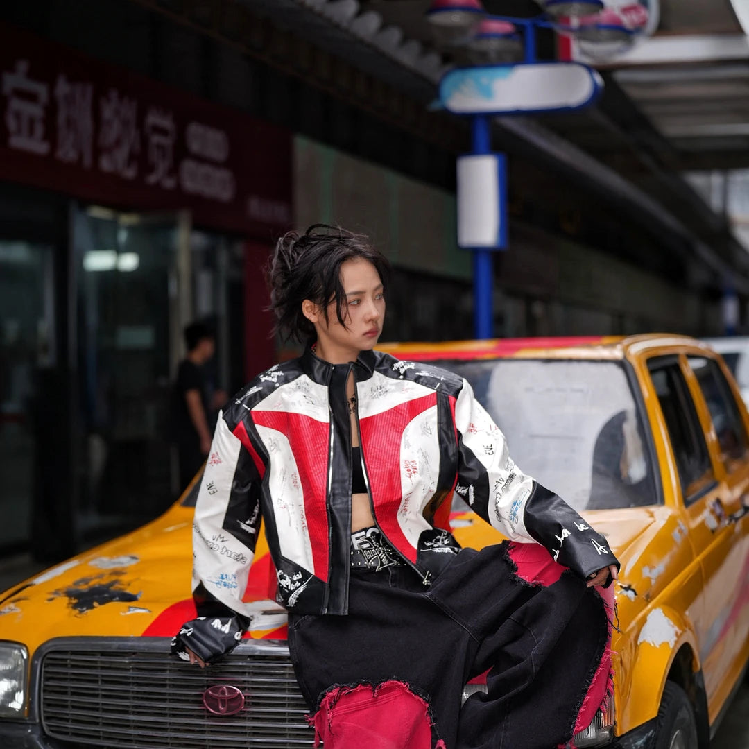 Sanhoostudio PU racing jacket featuring F2-inspired motorsport styling, contrast patchwork construction, and a relaxed oversized silhouette. Designed for early fall streetwear layering with bold racing character, comfortable movement, and distinctive urban appeal.
