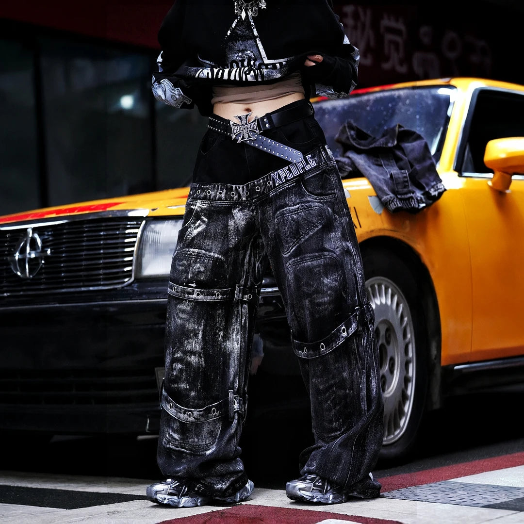 Sanhoostudio denim pants featuring heavyweight washed denim, distressed detailing, patchwork construction, and a relaxed wide leg scythe silhouette. Designed for bold streetwear styling with rugged vintage texture, comfortable movement, and versatile everyday urban wear.