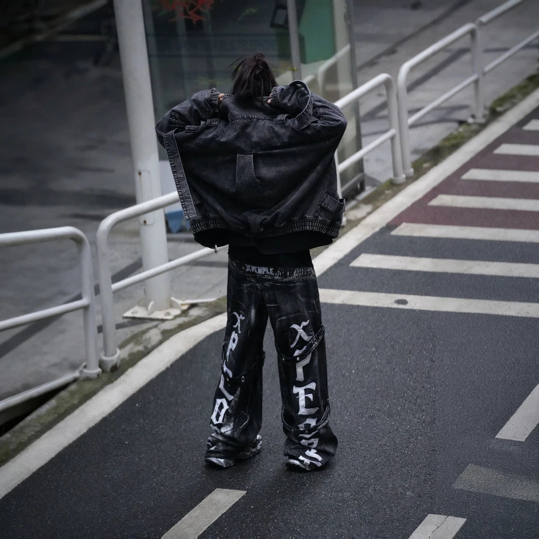 Sanhoostudio denim pants featuring heavyweight washed denim, distressed detailing, patchwork construction, and a relaxed wide leg scythe silhouette. Designed for bold streetwear styling with rugged vintage texture, comfortable movement, and versatile everyday urban wear.