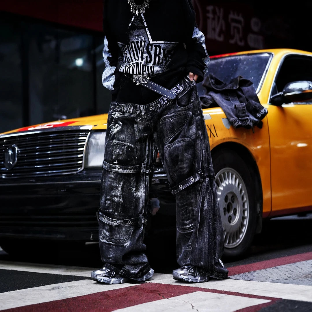 Sanhoostudio denim pants featuring heavyweight washed denim, distressed detailing, patchwork construction, and a relaxed wide leg scythe silhouette. Designed for bold streetwear styling with rugged vintage texture, comfortable movement, and versatile everyday urban wear.