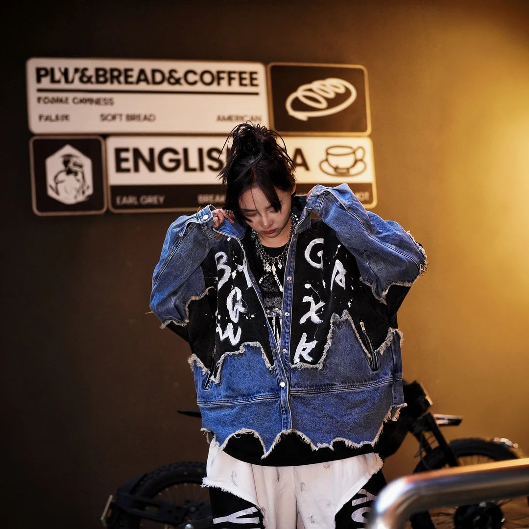 Sanhoostudio denim jacket featuring hand-painted graphics, distressed stain effects, brushed color detailing, mud-dye treatment, and a relaxed oversized silhouette. Designed for statement streetwear layering with rugged visual texture, vintage character, and distinctive everyday urban styling.