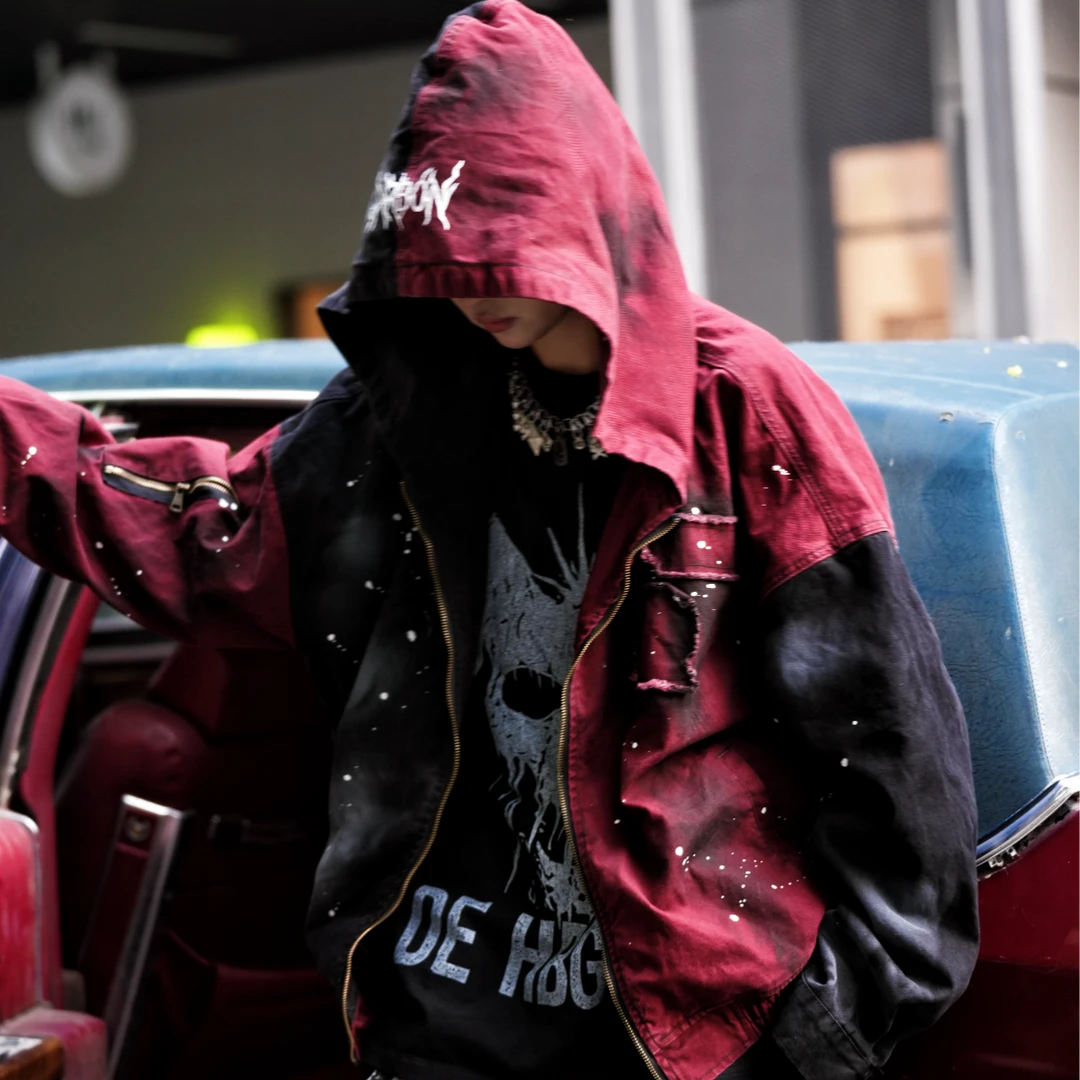 Sanhoostudio denim jacket featuring evil-eye inspired applique embroidery, distressed stain effects, and a relaxed oversized silhouette. Designed for statement streetwear layering with handcrafted visual details, rugged vintage texture, and distinctive dark urban character.