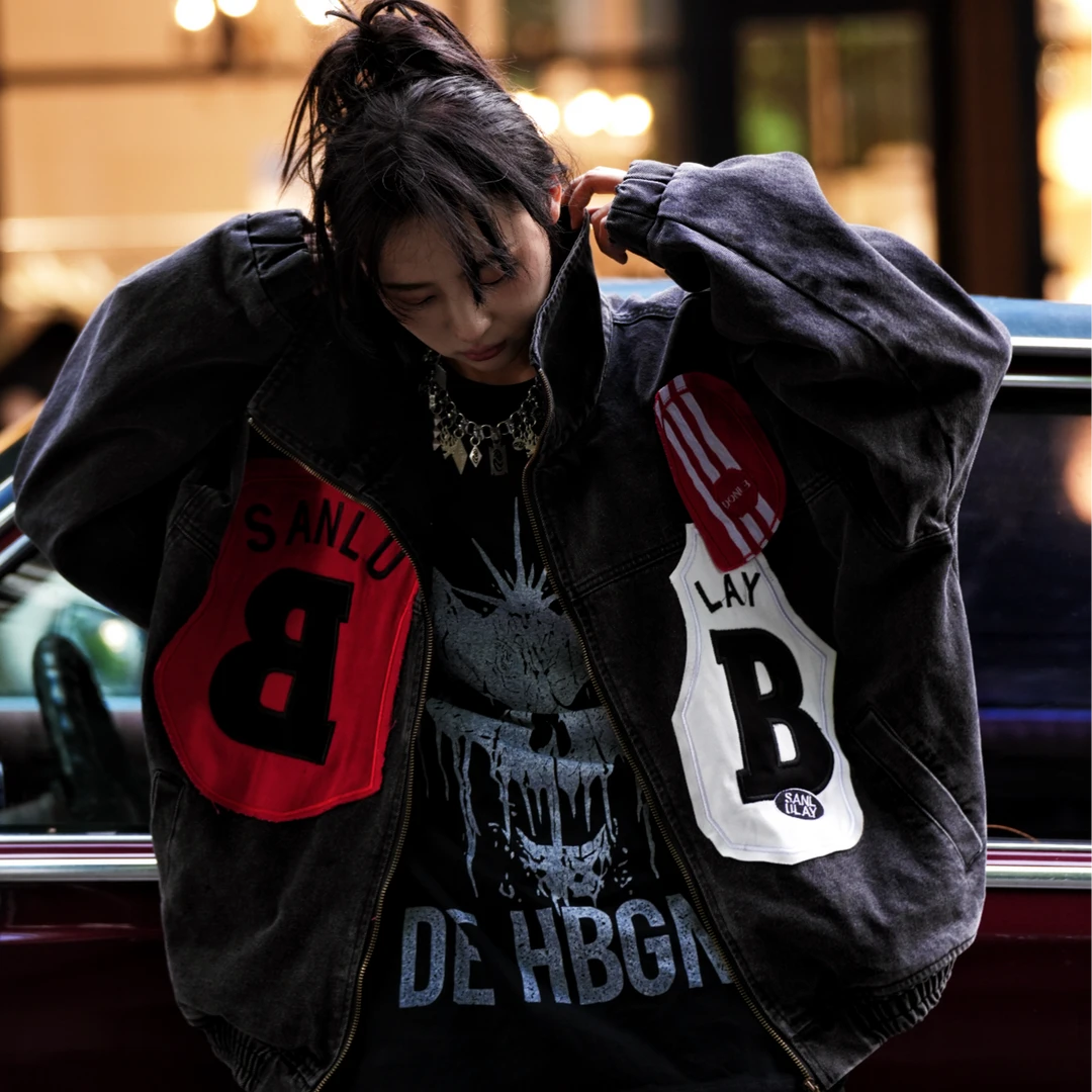 Sanhoostudio denim jacket featuring mixed patch applique embroidery, distressed stain effects, and a relaxed oversized silhouette. Designed for contemporary streetwear layering with handcrafted detailing, rugged denim texture, distinctive visual contrast, and bold everyday styling.