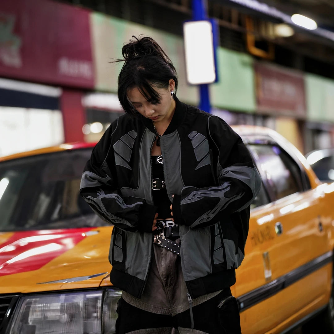 Sanhoostudio racing jacket featuring contrast patchwork construction, embroidered detailing, padded insulation, and a relaxed oversized silhouette. Designed for colder-season streetwear styling with vintage motorsport influence, comfortable warmth, bold visual structure, and versatile everyday layering.