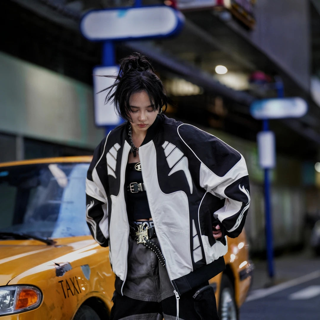 Sanhoostudio racing jacket featuring contrast patchwork construction, embroidered detailing, padded insulation, and a relaxed oversized silhouette. Designed for colder-season streetwear styling with vintage motorsport influence, comfortable warmth, bold visual structure, and versatile everyday layering.