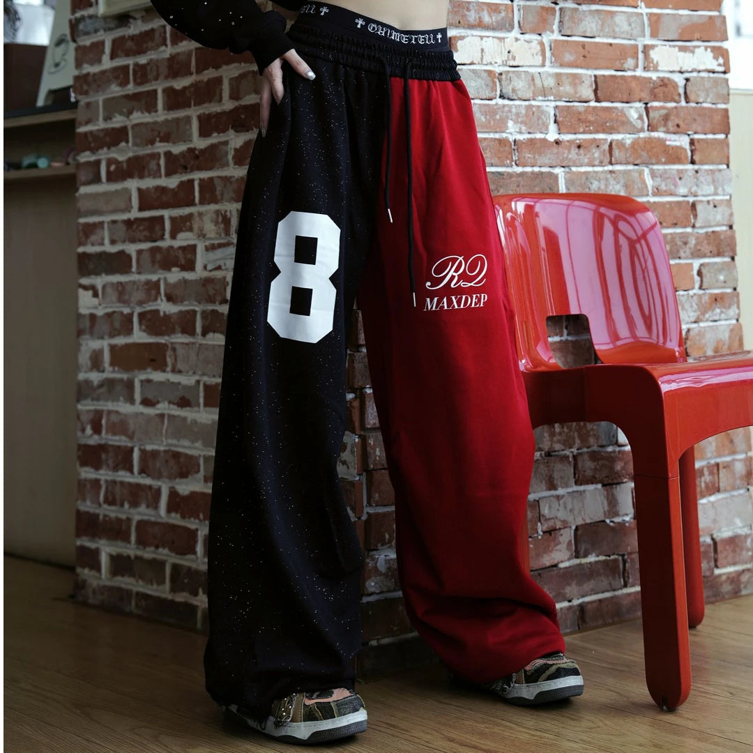 Sanhoostudio sweatpants featuring all-over rhinestone embellishments, contrast detailing, ruched texture, and a relaxed wide leg scythe silhouette. Designed for statement streetwear and dance-inspired styling with comfortable movement, bold visual texture, and distinctive urban appeal.