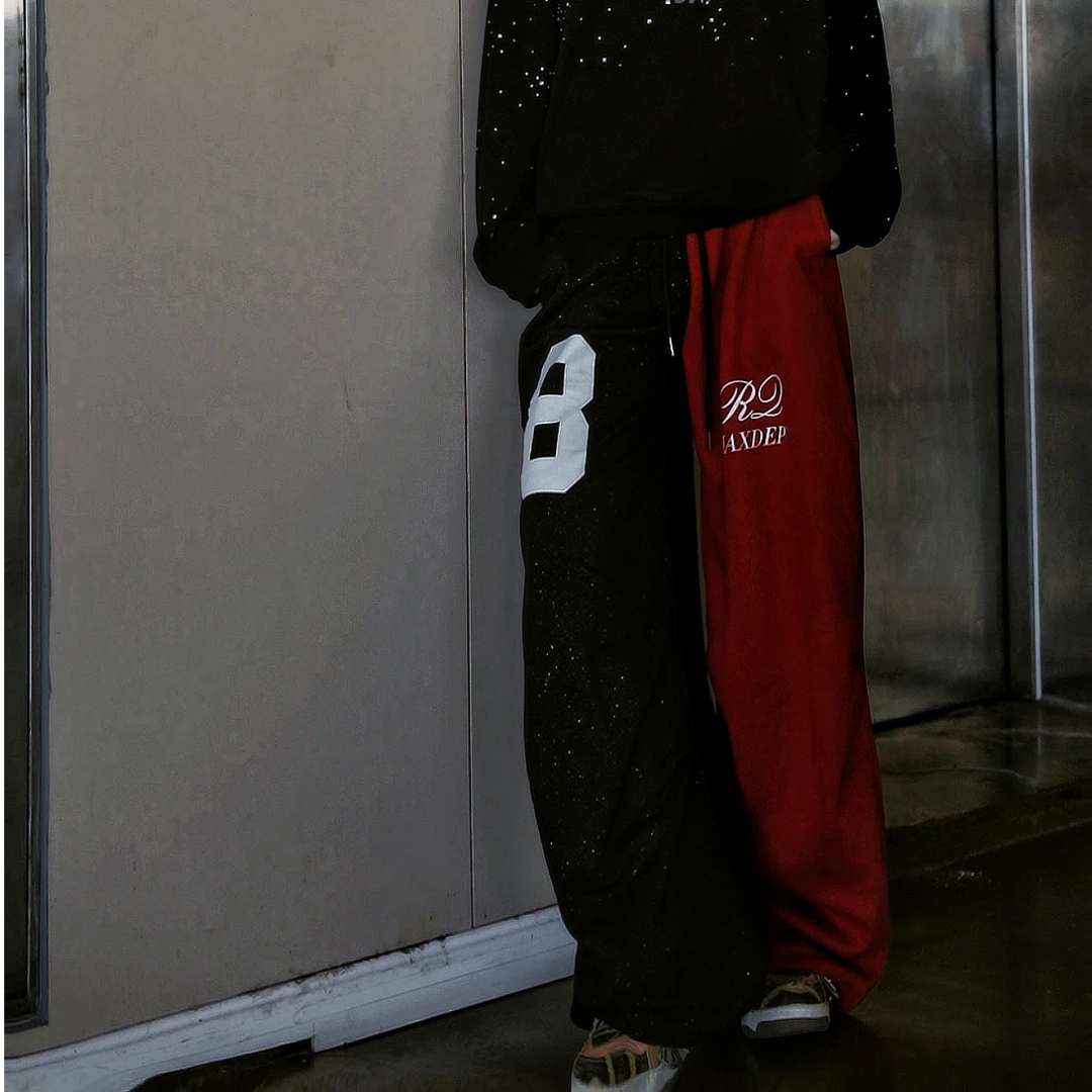 Sanhoostudio sweatpants featuring all-over rhinestone embellishments, contrast detailing, ruched texture, and a relaxed wide leg scythe silhouette. Designed for statement streetwear and dance-inspired styling with comfortable movement, bold visual texture, and distinctive urban appeal.