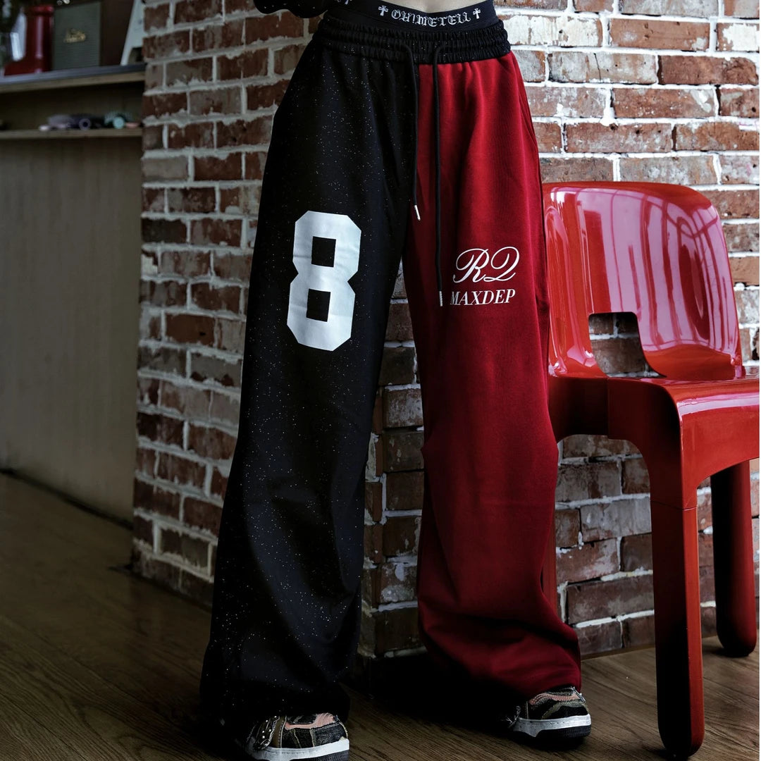 Sanhoostudio sweatpants featuring all-over rhinestone embellishments, contrast detailing, ruched texture, and a relaxed wide leg scythe silhouette. Designed for statement streetwear and dance-inspired styling with comfortable movement, bold visual texture, and distinctive urban appeal.