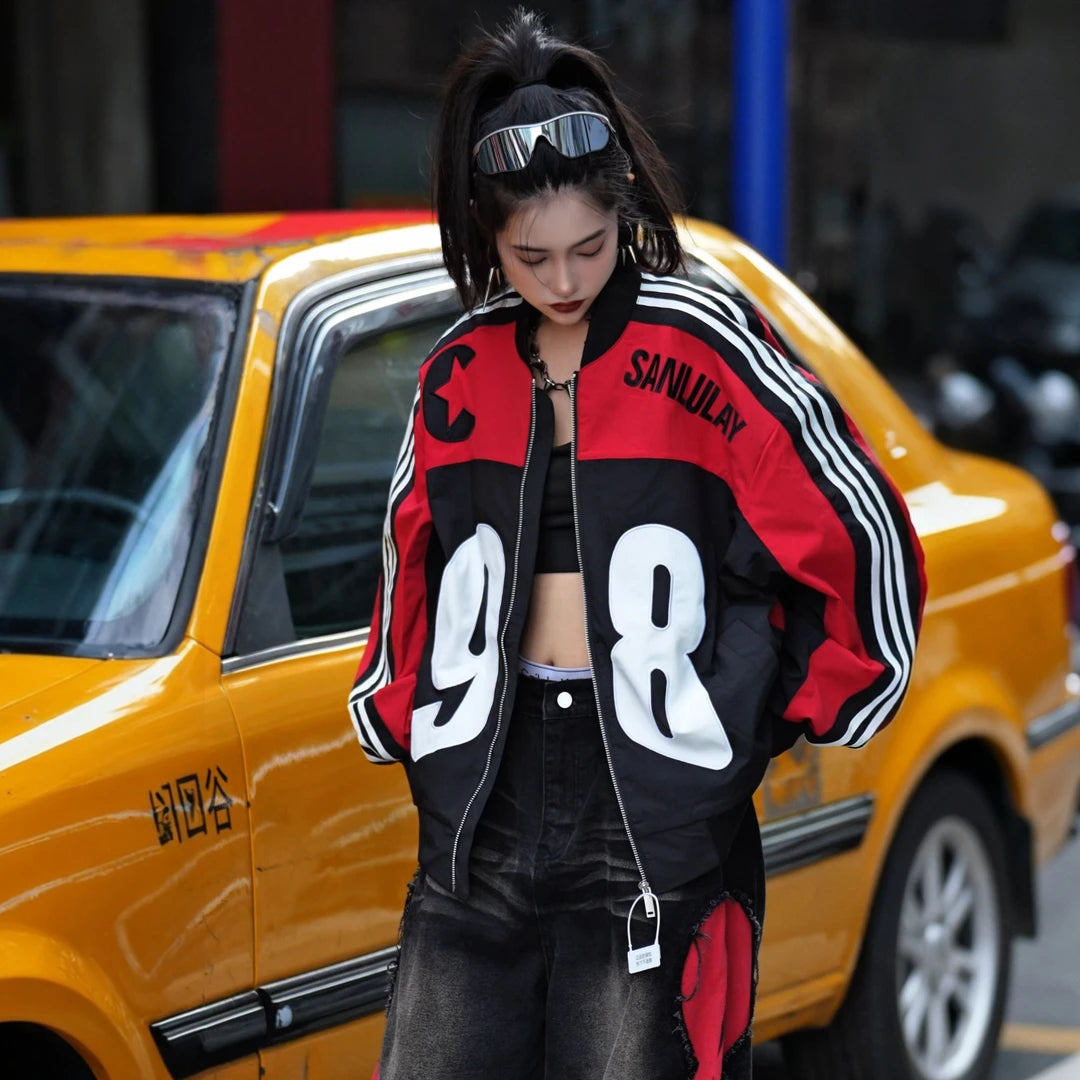 Sanhoostudio moto jacket featuring contrast colorblock panels, embroidered detailing, a structured stand collar, and a relaxed oversized silhouette. Designed with vintage motorcycle influence for bold streetwear layering, comfortable everyday wear, and distinctive urban styling.