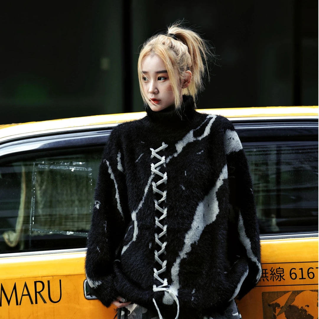 Sanhoostudio knit sweater featuring gothic-inspired lace-up detailing, a structured stand collar, heavyweight knitted construction, and a relaxed oversized silhouette. Designed for fall and winter streetwear styling with comfortable warmth, distinctive dark aesthetics, and versatile layering.