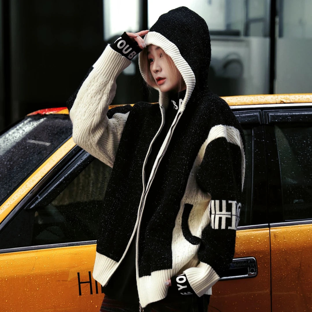 Sanhoostudio hooded knit cardigan featuring all-over star embellishments, contrasting colorblock panels, and a relaxed oversized silhouette. Designed for statement streetwear layering with comfortable knitted texture, distinctive visual detailing, versatile styling, and contemporary unisex appeal.