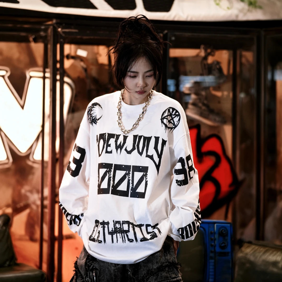Sanhoostudio long sleeve T-shirt featuring sun, moon, and star-inspired graphic artwork, creative spray print detailing, and a relaxed oversized silhouette. Designed for contemporary streetwear styling with soft breathable fabric, celestial visual elements, comfortable everyday wear, and distinctive artistic appeal.