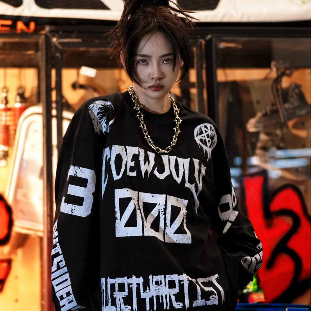 Sanhoostudio long sleeve T-shirt featuring sun, moon, and star-inspired graphic artwork, creative spray print detailing, and a relaxed oversized silhouette. Designed for contemporary streetwear styling with soft breathable fabric, celestial visual elements, comfortable everyday wear, and distinctive artistic appeal.