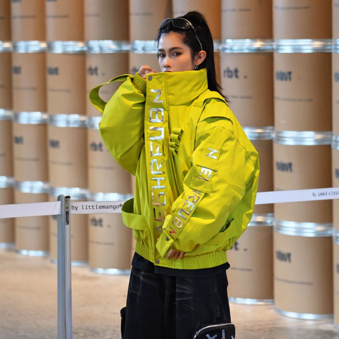 Sanhoostudio down jacket featuring reflective letter graphics, a structured stand collar, and a relaxed oversized silhouette. Designed for technical-inspired winter streetwear styling with comfortable insulation, bold reflective detailing, functional aesthetics, and versatile everyday layering.