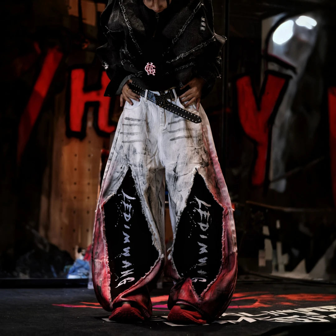 Sanhoostudio denim pants featuring a layered design, vintage washed treatment, distressed detailing, and asymmetric patchwork construction. Designed for statement streetwear styling with rugged denim texture, unconventional panel structure, relaxed proportions, and distinctive everyday urban appeal.