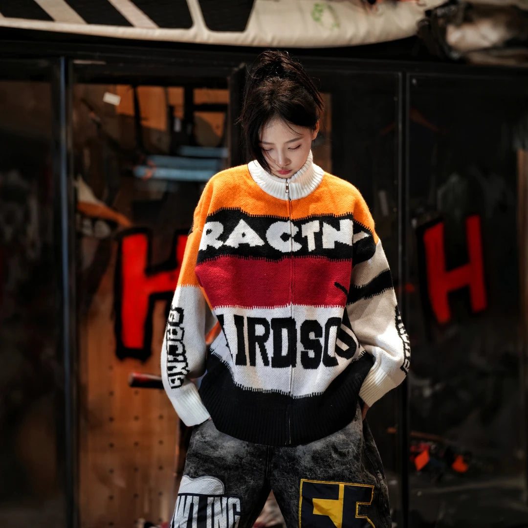 Sanhoostudio knit sweater featuring Suzuki-inspired colorblock detailing, heavyweight knitted construction, distressed graffiti artwork, and hand-painted patchwork elements. Designed with a relaxed oversized silhouette for statement streetwear styling, distinctive racing-inspired aesthetics, comfortable warmth, and bol