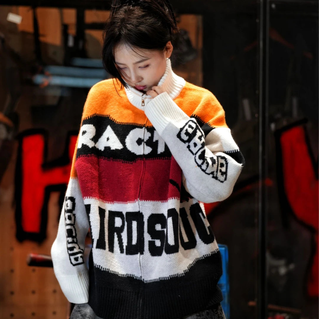 Sanhoostudio knit sweater featuring Suzuki-inspired colorblock detailing, heavyweight knitted construction, distressed graffiti artwork, and hand-painted patchwork elements. Designed with a relaxed oversized silhouette for statement streetwear styling, distinctive racing-inspired aesthetics, comfortable warmth, and bol