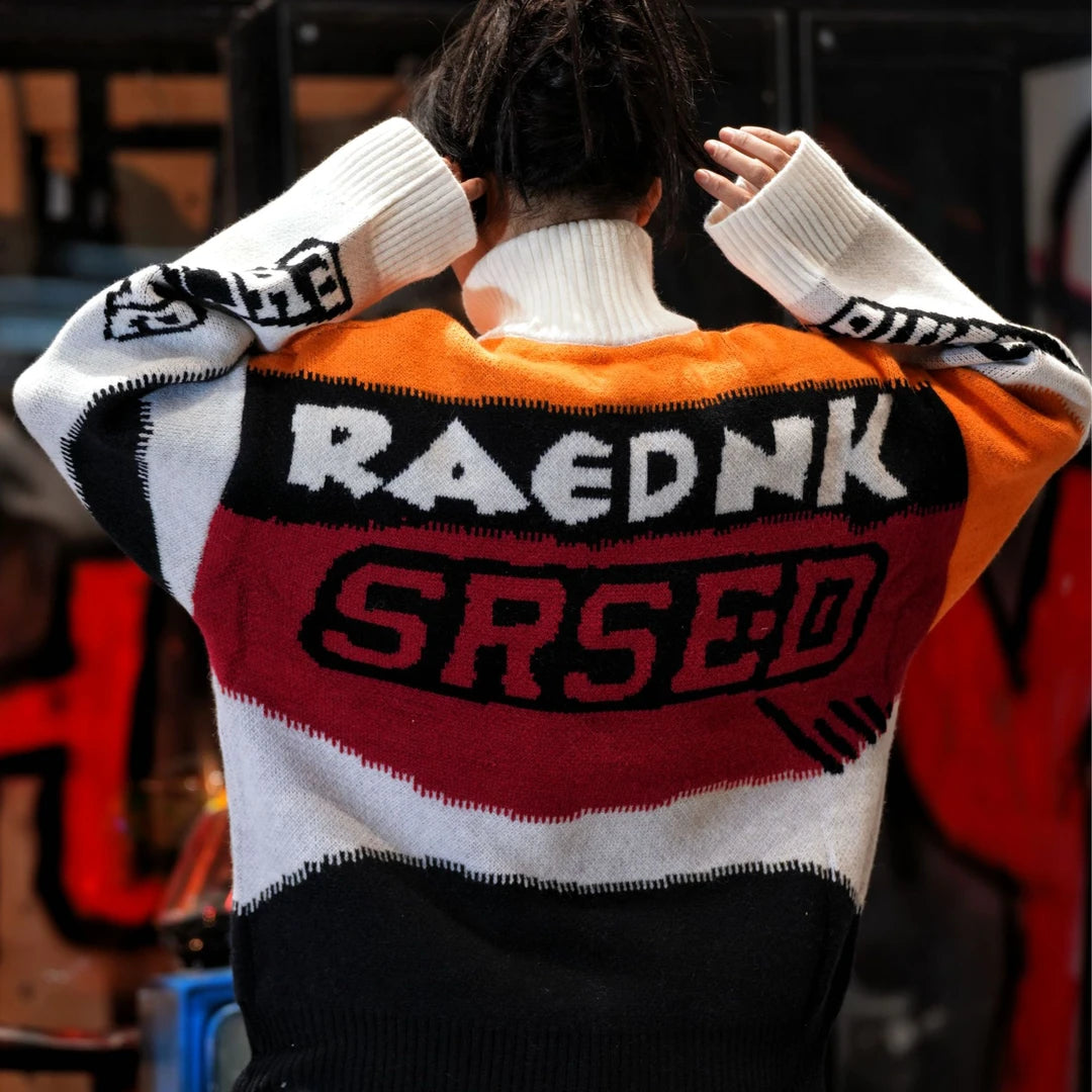 Sanhoostudio knit sweater featuring Suzuki-inspired colorblock detailing, heavyweight knitted construction, distressed graffiti artwork, and hand-painted patchwork elements. Designed with a relaxed oversized silhouette for statement streetwear styling, distinctive racing-inspired aesthetics, comfortable warmth, and bol