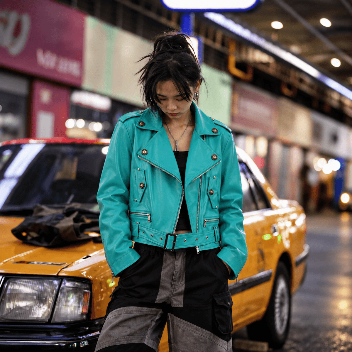 Sanhoostudio PU leather moto jacket featuring a statement green finish and a fitted cropped silhouette. Designed for bold motorcycle-inspired streetwear styling with sleek visual texture, distinctive proportions, and versatile layering for contemporary urban outfits.