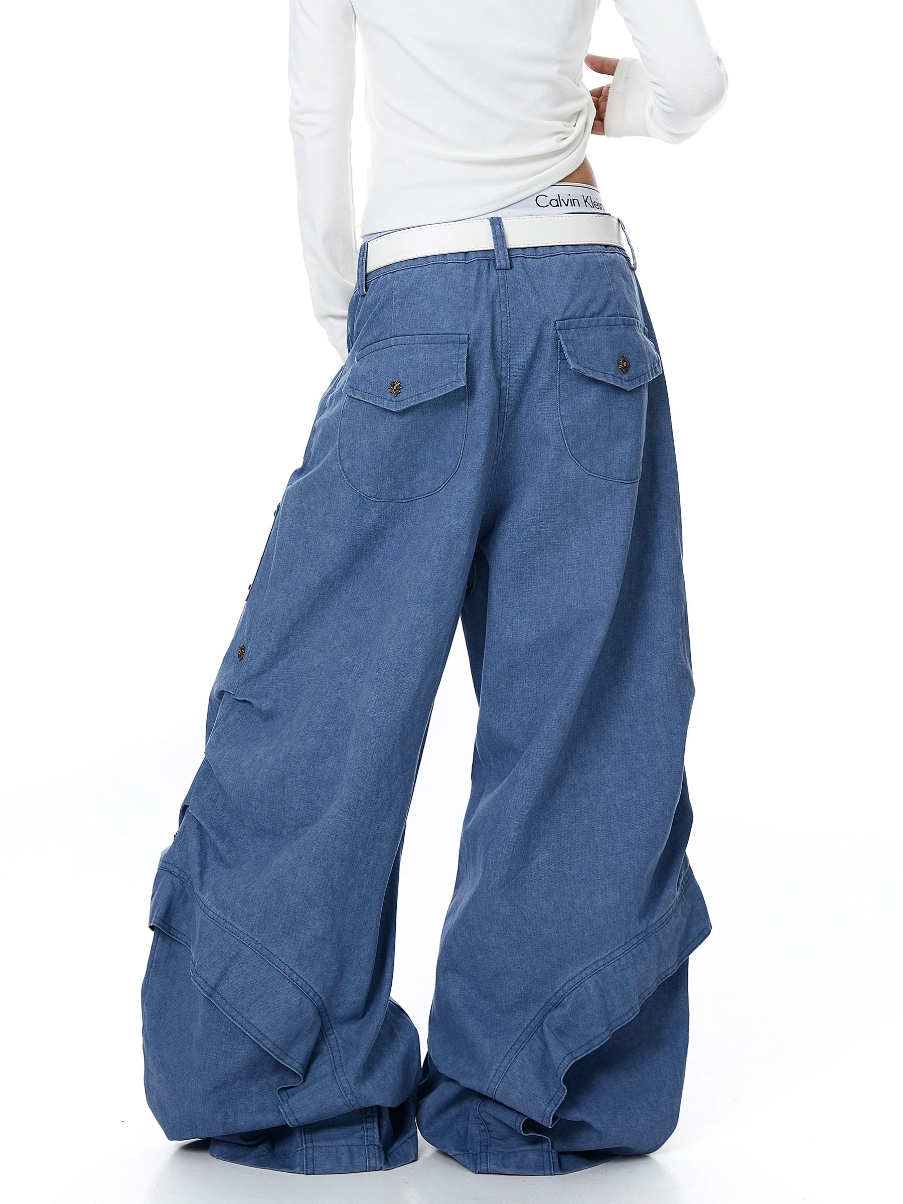 Sanhoostudio workwear denim pants featuring heavy patchwork construction and multiple utility pockets. Designed with a wide leg silhouette for modern streetwear outfits.