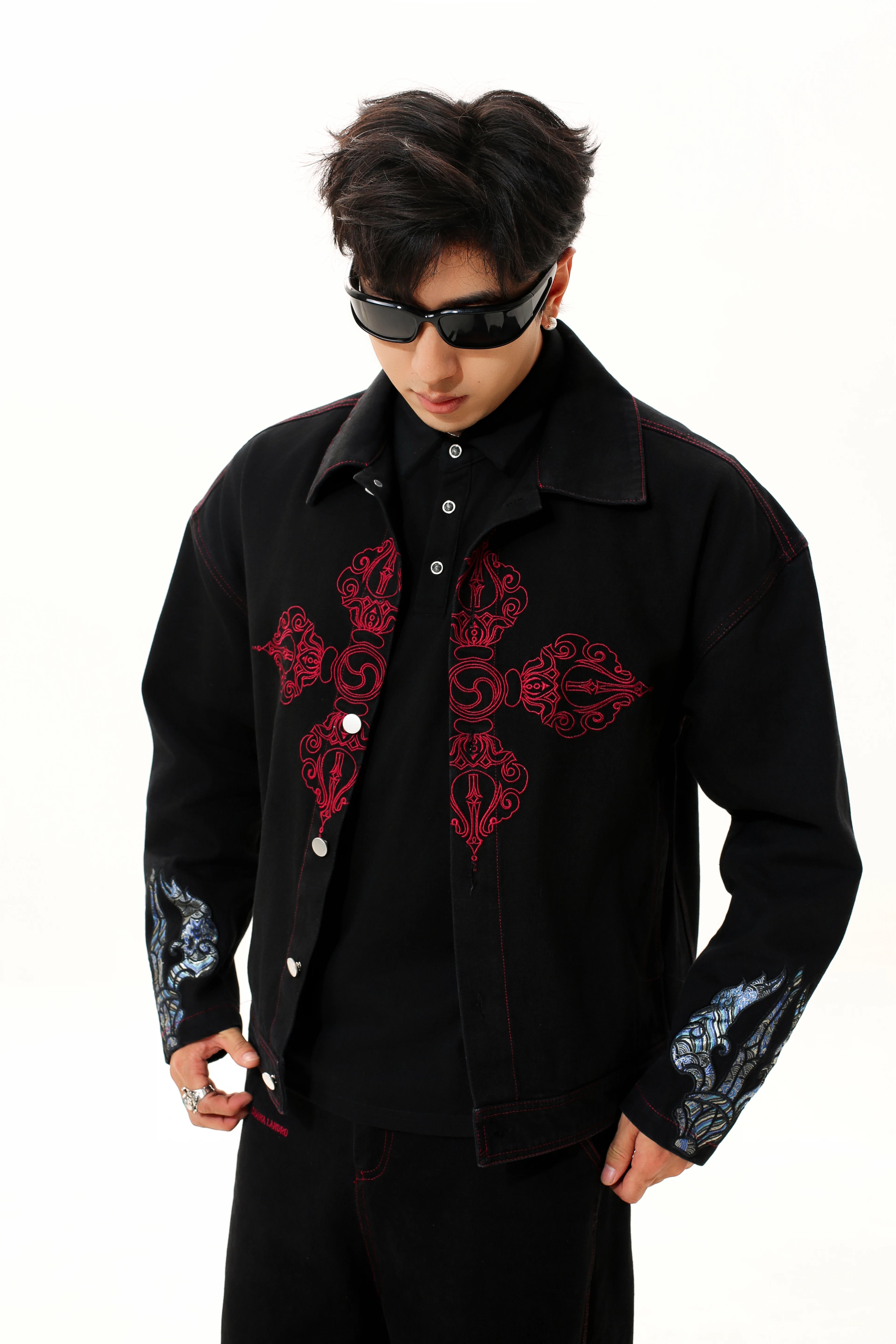 Sanhoostudio denim jacket featuring Vajra embroidery and a relaxed streetwear silhouette. Designed for unisex wear with durable denim fabric for fall styling.